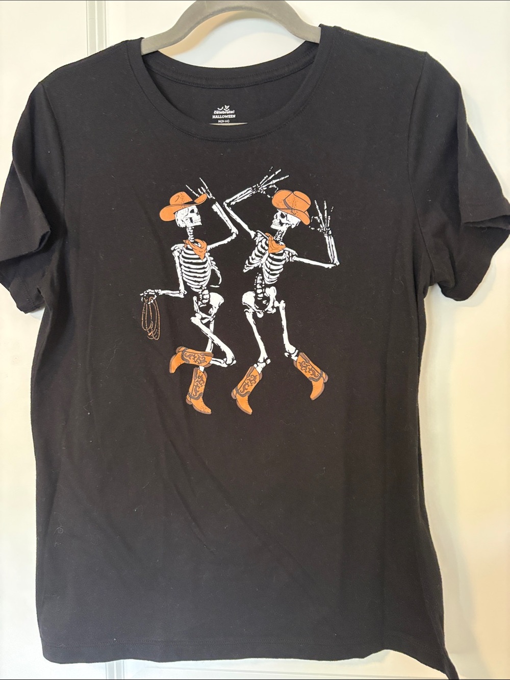 Women Black Graphic Tee with Orange Cowboy Skeleton Design